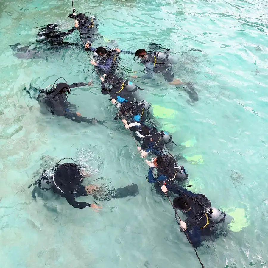 Group of divers exploring the coral reefs in Semporna Sagittarius Resort